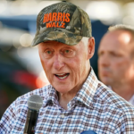 bill clinton wearing a harriz-walz camo hat