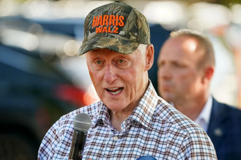 bill clinton wearing a harriz-walz camo hat