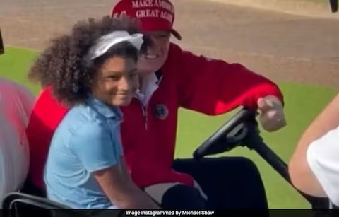 trump with young golfer with beautiful hair